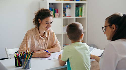 boy having conversation with psychologist for enrollment in school